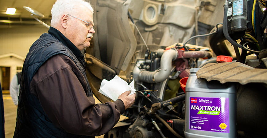 Man checking oil with Maxtron Enviro-Edge