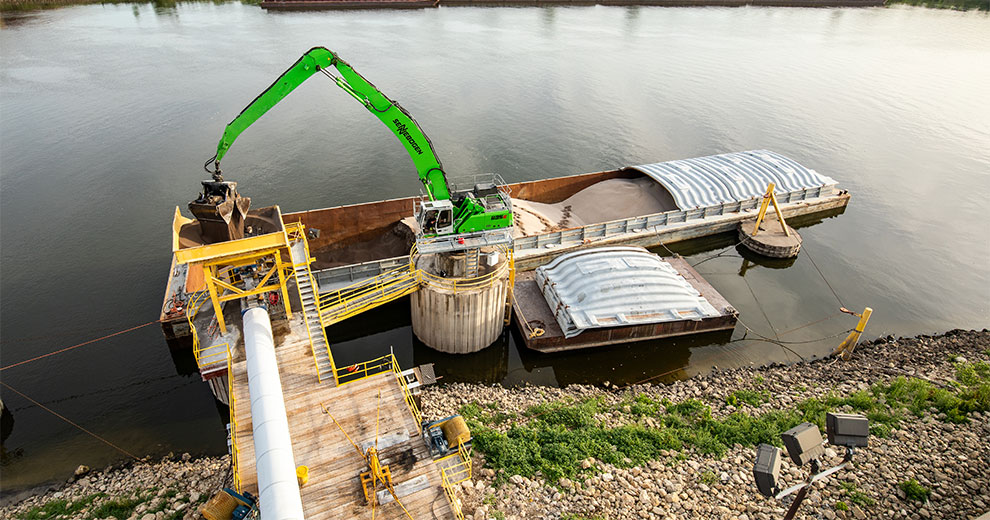 Crane loading a barge with fertilizer