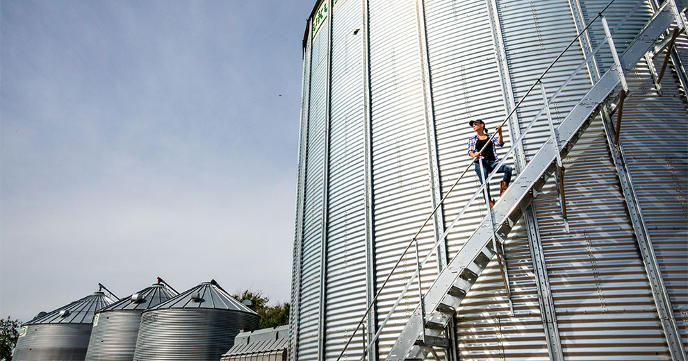 Woman climbing the stairs encircling a silo