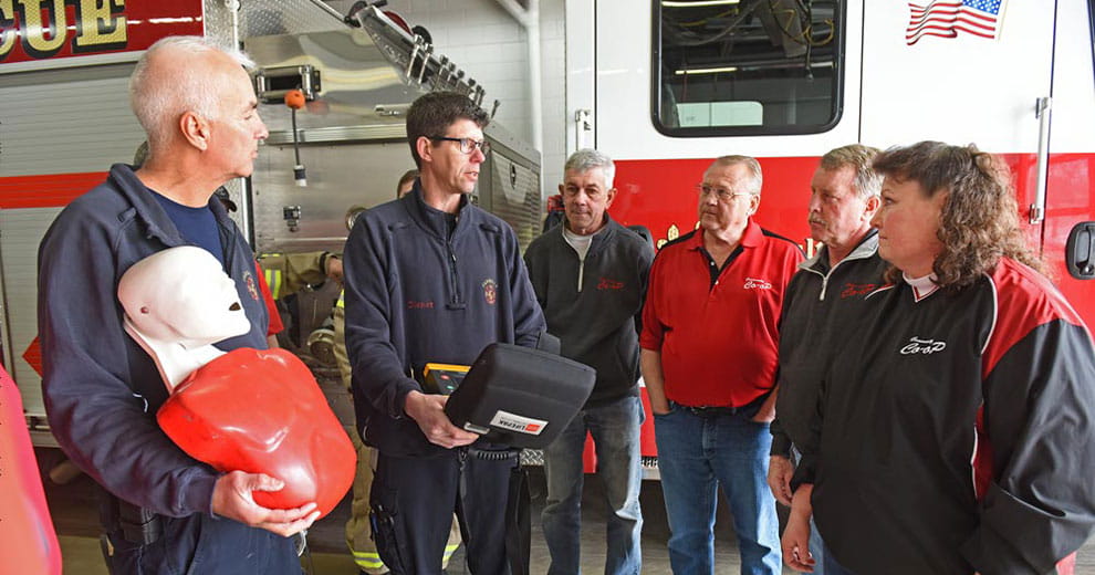 Firefighters looking at a LifePak defibrillator