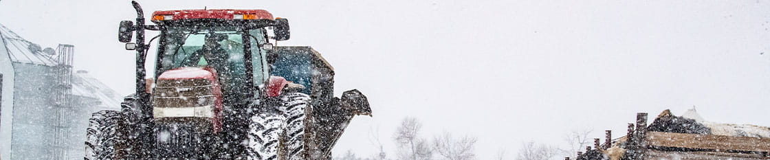 Tractor driving through snowstorm