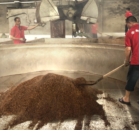Workers using sorghum to make Baiju, a Chinese spirit. 