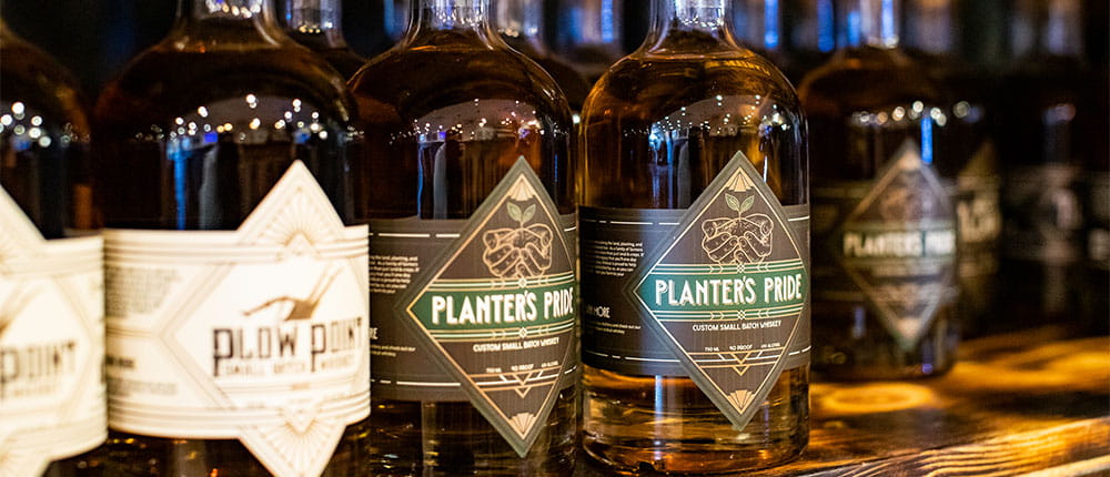 Bottles of Planter’s Pride whiskey displayed on a shelf