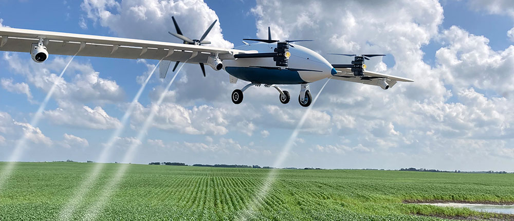 An autonomous drone flying over a field spraying plant-level herbicide applications