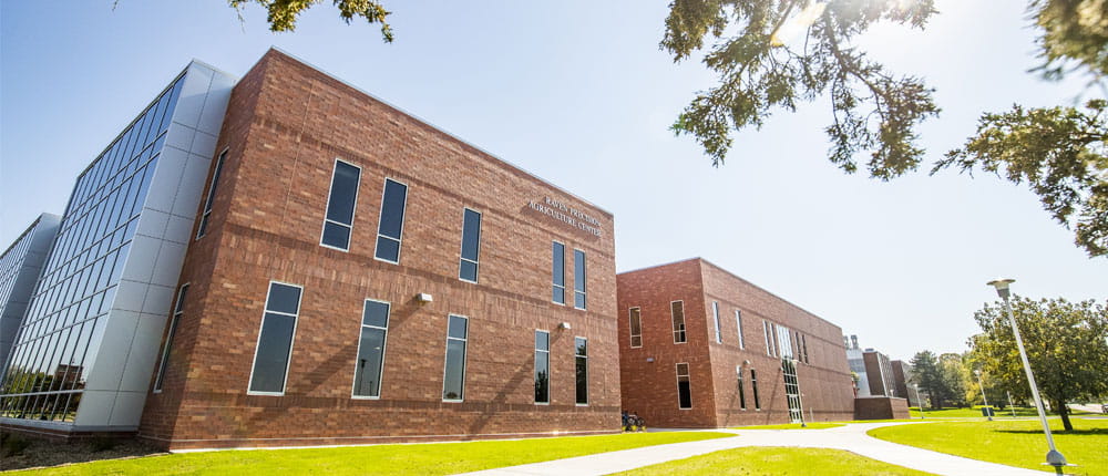 The new Raven Precision Agriculture Center at SDSU is pictured, a brick building with grass.