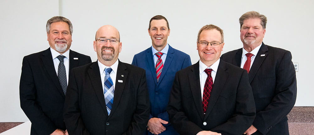 Five board members posing for a photo