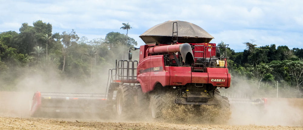 A combine clears a field during harvest in Brazil.  