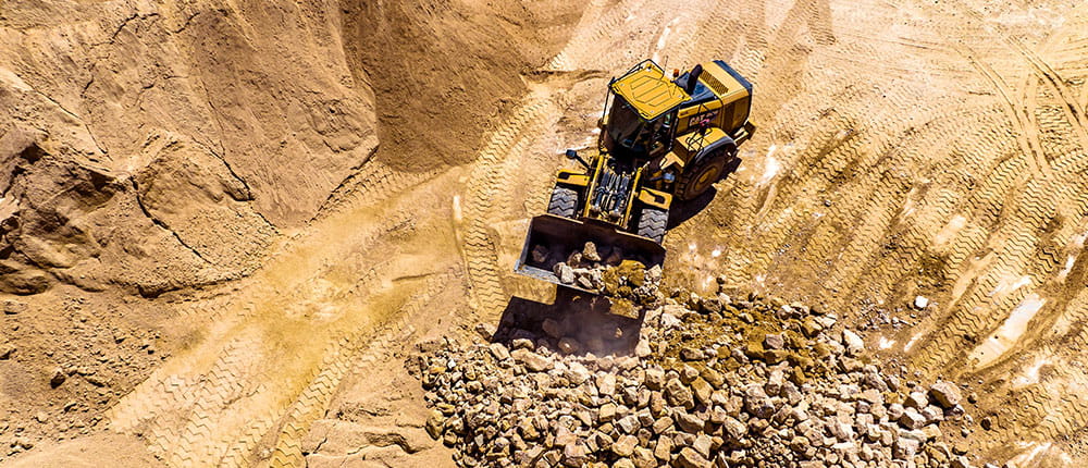 Looking down at construction equipment in quarry