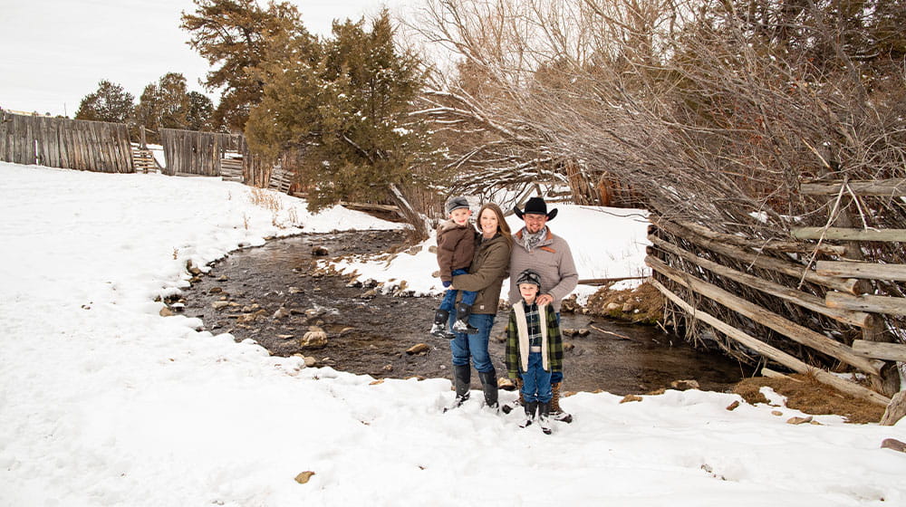 Family standing by a creek in winter